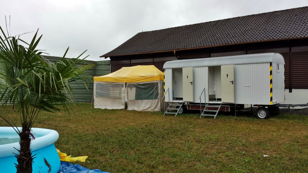 Greatest shower in the world in the tent next to the toilet car.