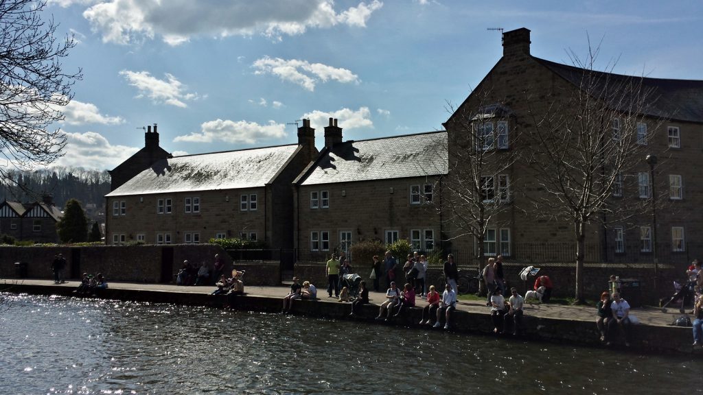 Tourists sunbathing along River Wye; Bakewell