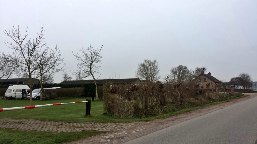 The road is in Belgium, the buildings and the vehicles are in the Netherlands