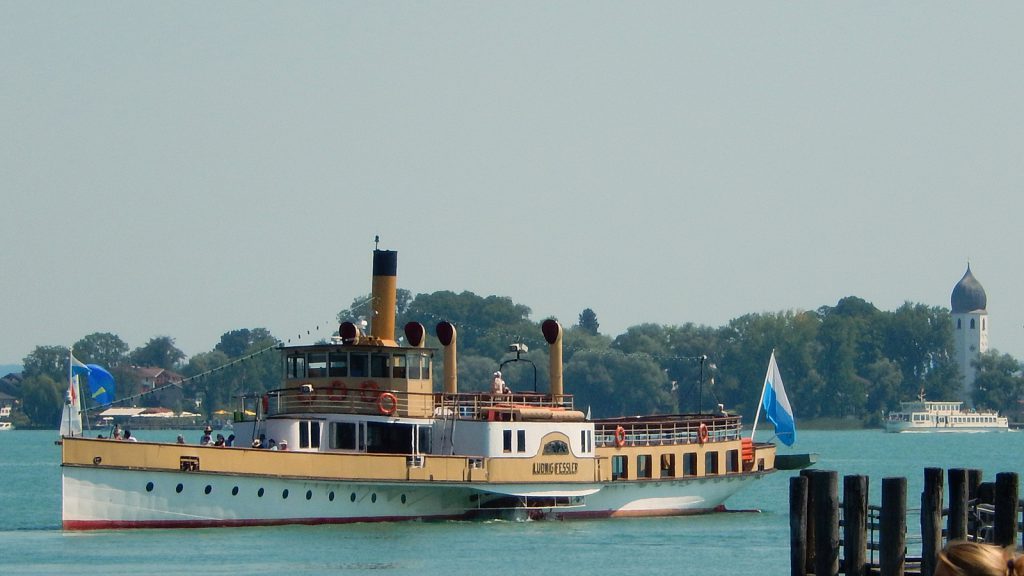 Boat on Lake Chiemsee, Fraueninsel and monastery tower in the background